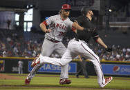 Arizona Diamondbacks' Caleb Smith gets tagged out by Los Angeles Angels' Alex Cobb (38) after laying down a sacrifice bunt in the third inning during a baseball game, Saturday, June 12, 2021, in Phoenix. (AP Photo/Rick Scuteri)