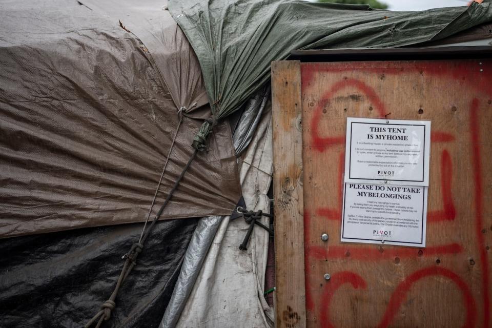 A sign reading “this tent is my home” is seen at crab park in Vancouver, B.C. on August 8, 2023. 