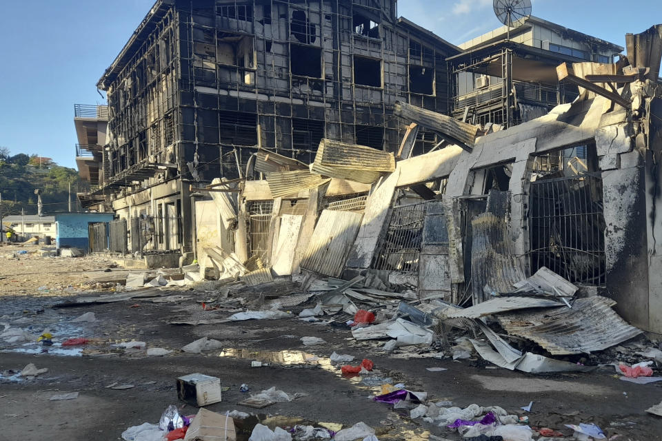 This photo shows aftermath of a looted street in Honiara's Chinatown, Solomon Islands, Saturday, Nov. 27, 2021. Violence receded Friday in the capital of the Solomon Islands, but the government showed no signs of addressing the underlying grievances that sparked two days of riots, including concerns about the country's increasing links with China. (AP Photo/Piringi Charley)