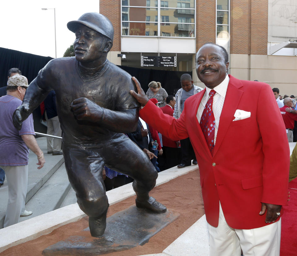 FILE - In this Saturday, Sept. 7, 2013, file photo, Hall of Fame second baseman Joe Morgan poses with his statue that was unveiled at Great American Ball Park, in Cincinnati. Joe Morgan has died. A family spokesman says he died at his home Sunday, Oct. 11, 2020, in Danville, Calif.(AP Photo/David Kohl, File)