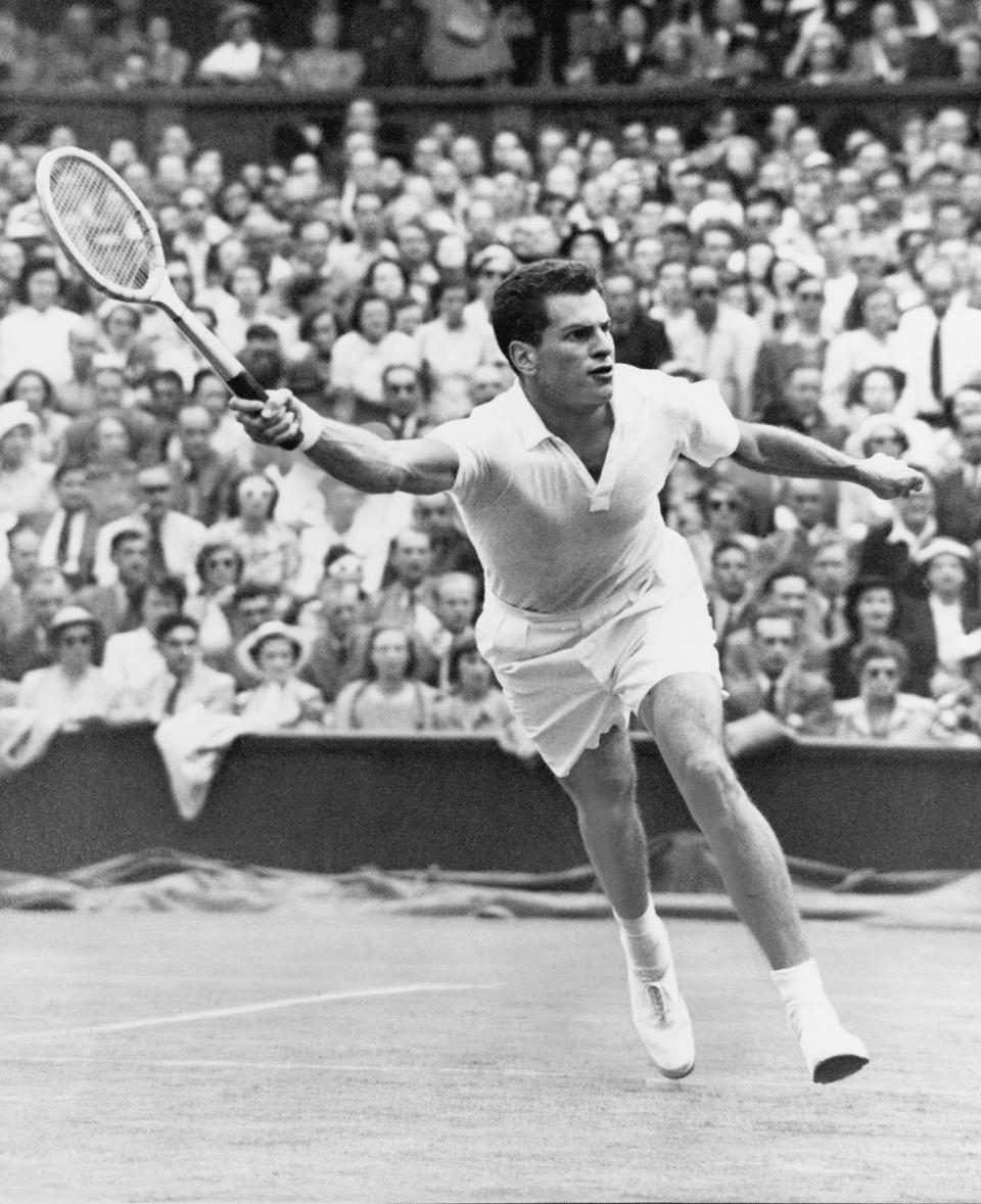 FILE - Dick Savitt of Orange, N.J., lunges for a shot during Herb Flam in the semifinals of All-England Tennis Championship at Wimbledon, England, on July 6, 1951. Savitt, who won the Australian Open and Wimbledon in 1951 shortly before walking away from a tennis career at age 25, passed away at home in New York on Friday, Jan. 6, 2023. He was 95. (AP Photo/File)