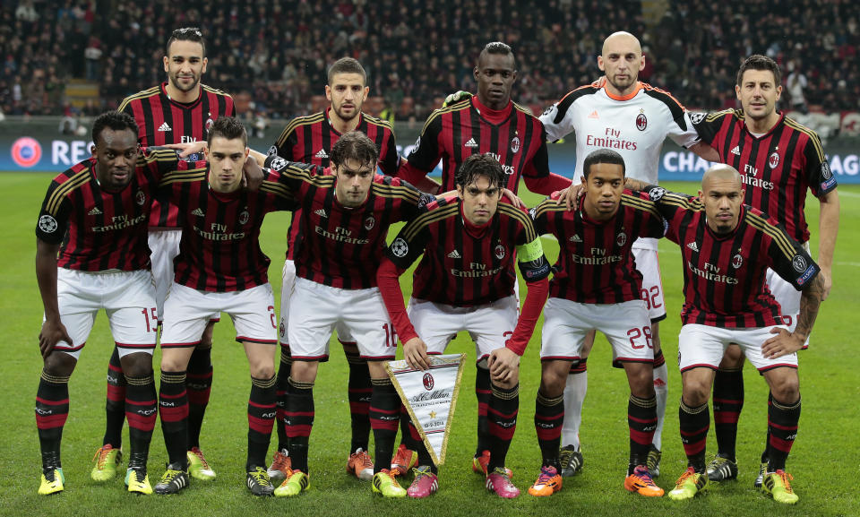 AC Milan's players, background from left, Adil Rami, Adel Taarabt, Mario Balotelli, goalie Christian Abbiati, Daniele Bonera, front row from left, Michael Essien, Mattia De Sciglio, Andrea Poli, Ricardo Kaka, Urby Emanuelson, and Nigel De Jong, pose for a picture before the start of a round of 16th Champions League soccer match between AC Milan and Atletico Madrid at the San Siro stadium in Milan, Italy, Wednesday, Feb. 19, 2014. (AP Photo/Emilio Andreoli)