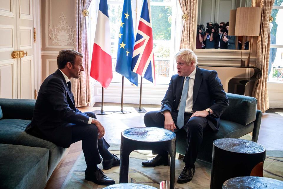 French President Emmanuel Macron, left, talks to Prime Minister Boris Johnson (AP)