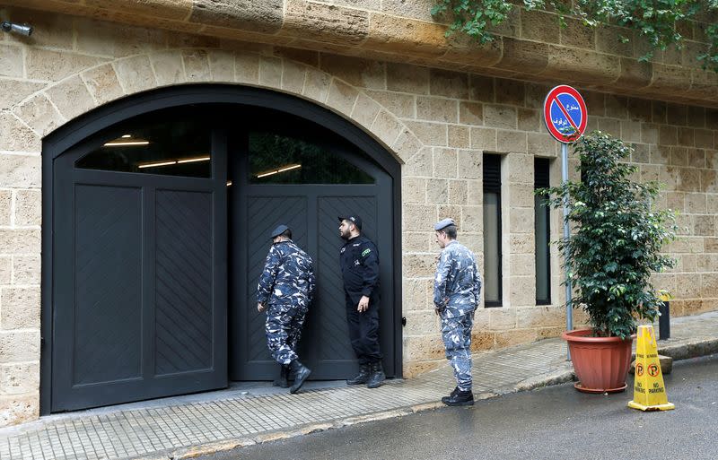 Lebanese police officers are seen at the entrance to the garage of what is believed to be Carlos Ghosn's house in Beirut