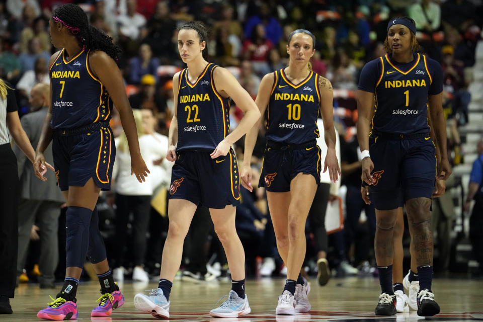 UNCASVILLE, CONNECTICUT - SEPTEMBER 22: Aliyah Boston #7, Caitlin Clark #22, Lexie Hull #10 and NaLyssa Smith #1 walk the court during a timeout during the first half of a first round WNBA playoff game against the Connecticut Sun at Mohegan Sun Arena on September 22, 2024 in Uncasville, Connecticut. NOTE TO USER: User expressly acknowledges and agrees that, by downloading and or using this photograph, User is consenting to the terms and conditions of the Getty Images License Agreement. (Photo by Joe Buglewicz/Getty Images)