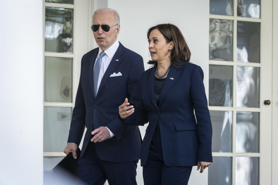 President Joe Biden and Vice President Kamala Harris walk back to the Oval Office after an event about gun violence in the Rose Garden.