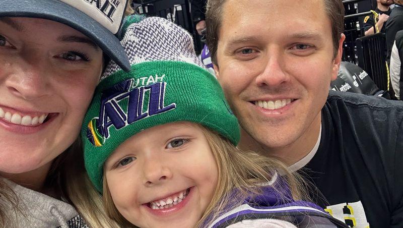 Ivorie Hadley, center, poses with her parents, Brett and McKenzie Hadley, at a recent Utah Jazz game.