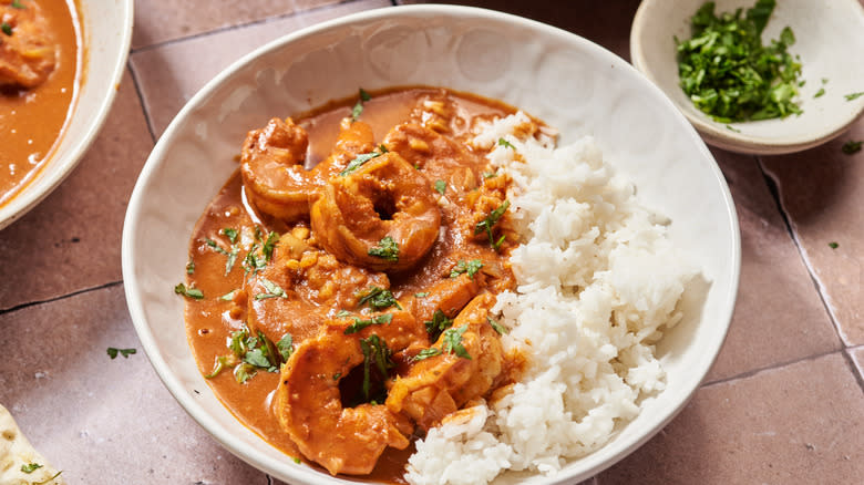 shrimp tikka masala in white bowl with white rice