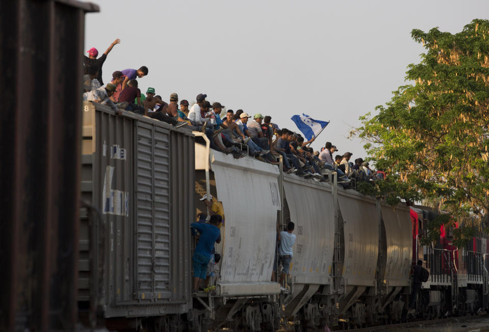 FILE - In this April 23, 2019 file photo, Central American migrants ride atop a freight train during their journey toward the U.S.-Mexico border, in Ixtepec, Oaxaca State, Mexico. Mexico said in Friday, Sept. 5, that it has complied with a 90-day deadline from the U.S. to reduce the flow of migrants through its territory, but activists say Mexico’s crackdown has only forced migrants into greater desperation and more illicit, dangerous routes. (AP Photo/Moises Castillo, File)