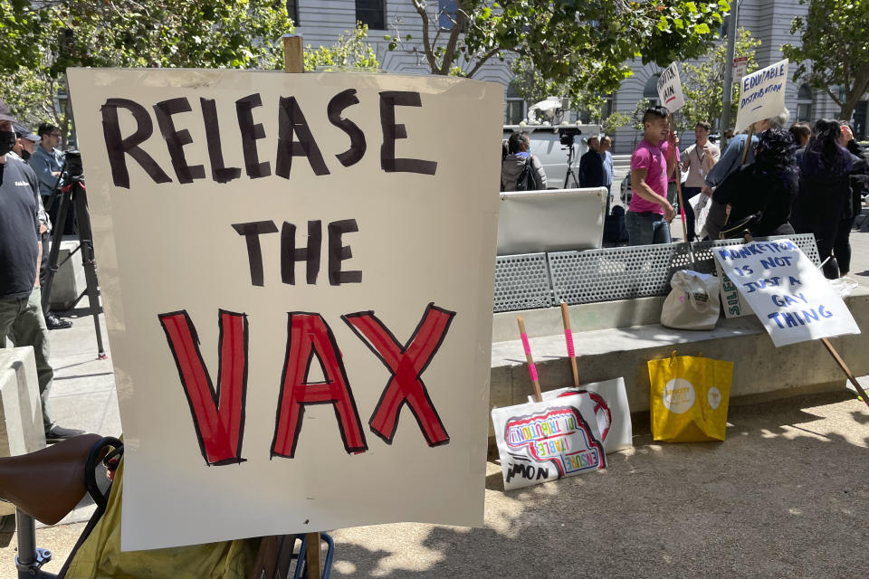 FILE - A sign urges the release of the monkeypox vaccine during a protest in San Francisco, July 18, 2022. The mayor of San Francisco announced a legal state of emergency Thursday, July 28, 2022, over the growing number of monkeypox cases. Public health officials warn that moves by rich countries to buy large quantities of monkeypox vaccine, while declining to share doses with Africa, could leave millions of people unprotected against a more dangerous version of the disease and risk continued spillovers of the virus into humans. (AP Photo/Haven Daley, File)