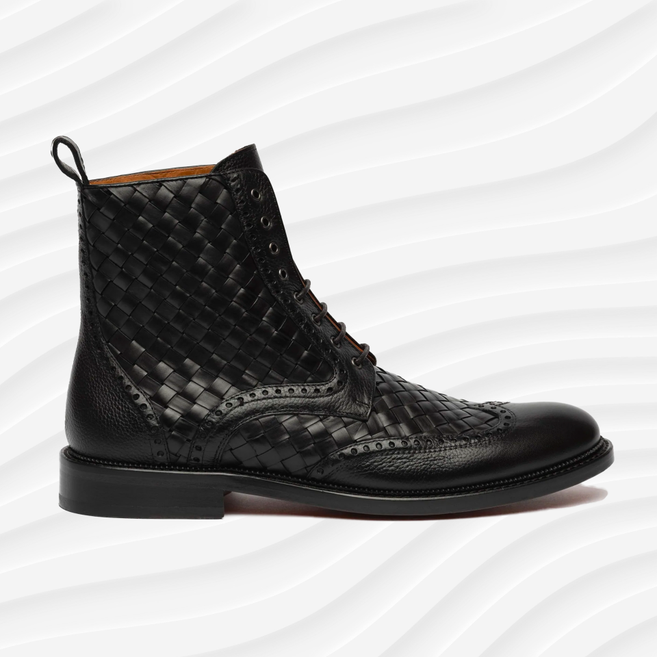 the Taft saint boot in black on a white wavy background