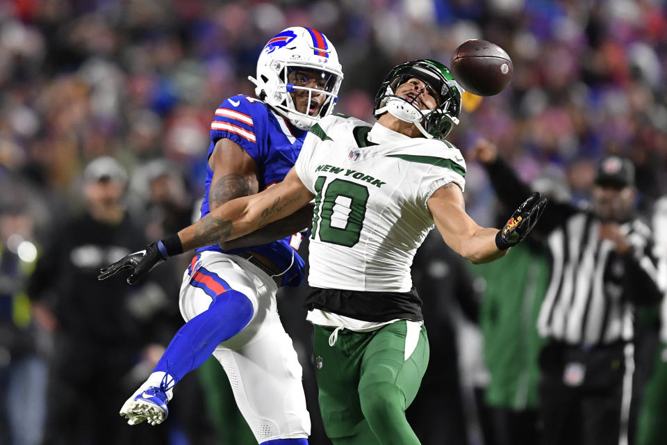 New York Jets wide receiver Allen Lazard (10) catches a pass with Buffalo Bills cornerback Rasul Douglas defending during the second half of an NFL football game in Orchard Park, N.Y., Sunday, Nov. 19, 2023. Douglas was called for pass interference on the play. (AP Photo/Adrian Kraus)