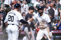 Detroit Tigers' Riley Greene, right, celebrates scoring with Spencer Torkelson (20) as Minnesota Twins pitcher Griffin Jax (22) walks back to the mound in the eighth inning of a baseball game, Sunday, April 14, 2024, in Detroit. (AP Photo/Paul Sancya)