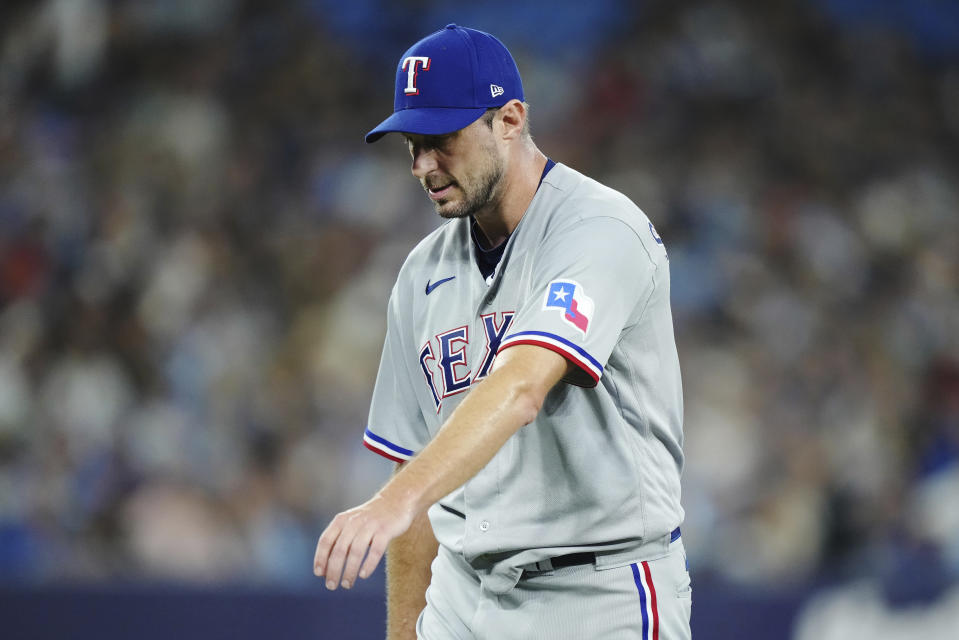 Texas Rangers starting pitcher Max Scherzer stretches his arm as he leaves the team's baseball game against the Toronto Blue Jays with an injury during the sixth inning Tuesday, Sept. 12, 2023, in Toronto. (Nathan Denette/The Canadian Press via AP)