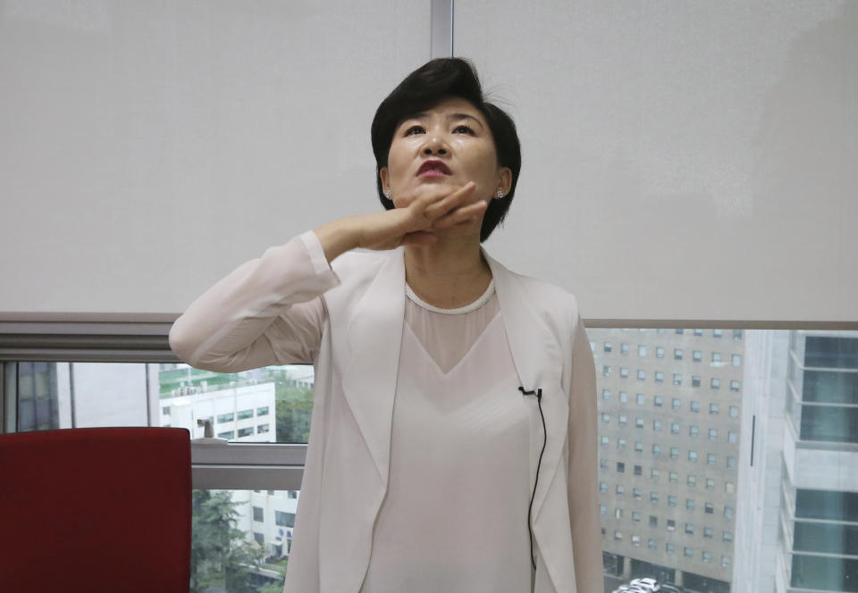 In this Aug. 28, 2018, photo, North Korean defector Kim Jungah gestures while speaking about North Korean military goose steps during an interview in Seoul, South Korea. Goose-stepping soldiers are the most spectacular part of North Korea’s massive military parades. Kim was once proud of her marching but now feels she was physically abused. (AP Photo/Ahn Young-joon)