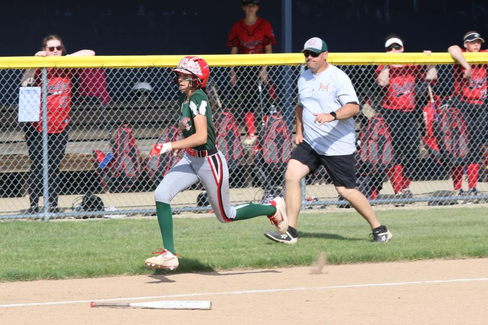 Oak Harbor's Reese Adkins looks to score as coach Chris Rawski follows the play.