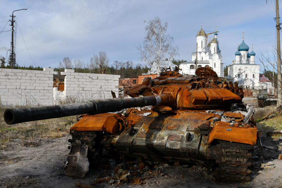 A destroyed Russian tank in front of an orthodox temple in the town of Sviatohirsk.