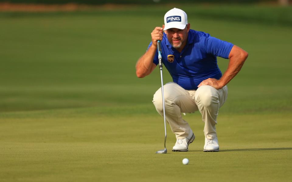 Lee Westwood of England lines up a putt - Mike Ehrmann/Getty Images
