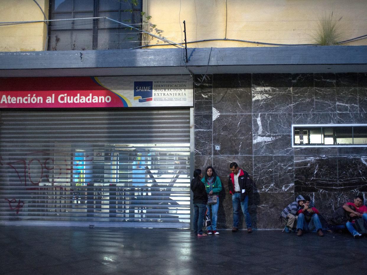 People wait in line outside Saime offices in Caracas: Getty