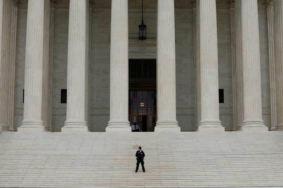 A law enforcement official stands on the steps of the U.S. Supreme Court Building on October 03, 2022.