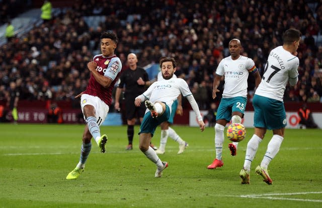 Ollie Watkins, left, scores against Manchester City