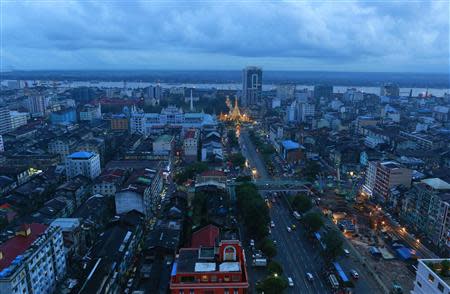 A general view of the city is seen, with an illuminated Sule Pagoda standing out from amongst the other buildings, in central Yangon September 6, 2013. REUTERS/Soe Zeya Tun