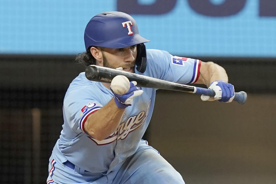 Texas Rangers Charlie Culberson hits a sacrifice fly that scores teammate Nick Solak during the third inning of a baseball game against the Atlanta Braves in Arlington, Texas, Sunday, May 1, 2022. (AP Photo/LM Otero)