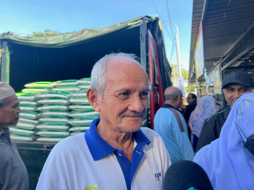 Idris Che Med, 65, came early to get his supply of local white rice for his family of seven. — Picture by Opalyn Mok