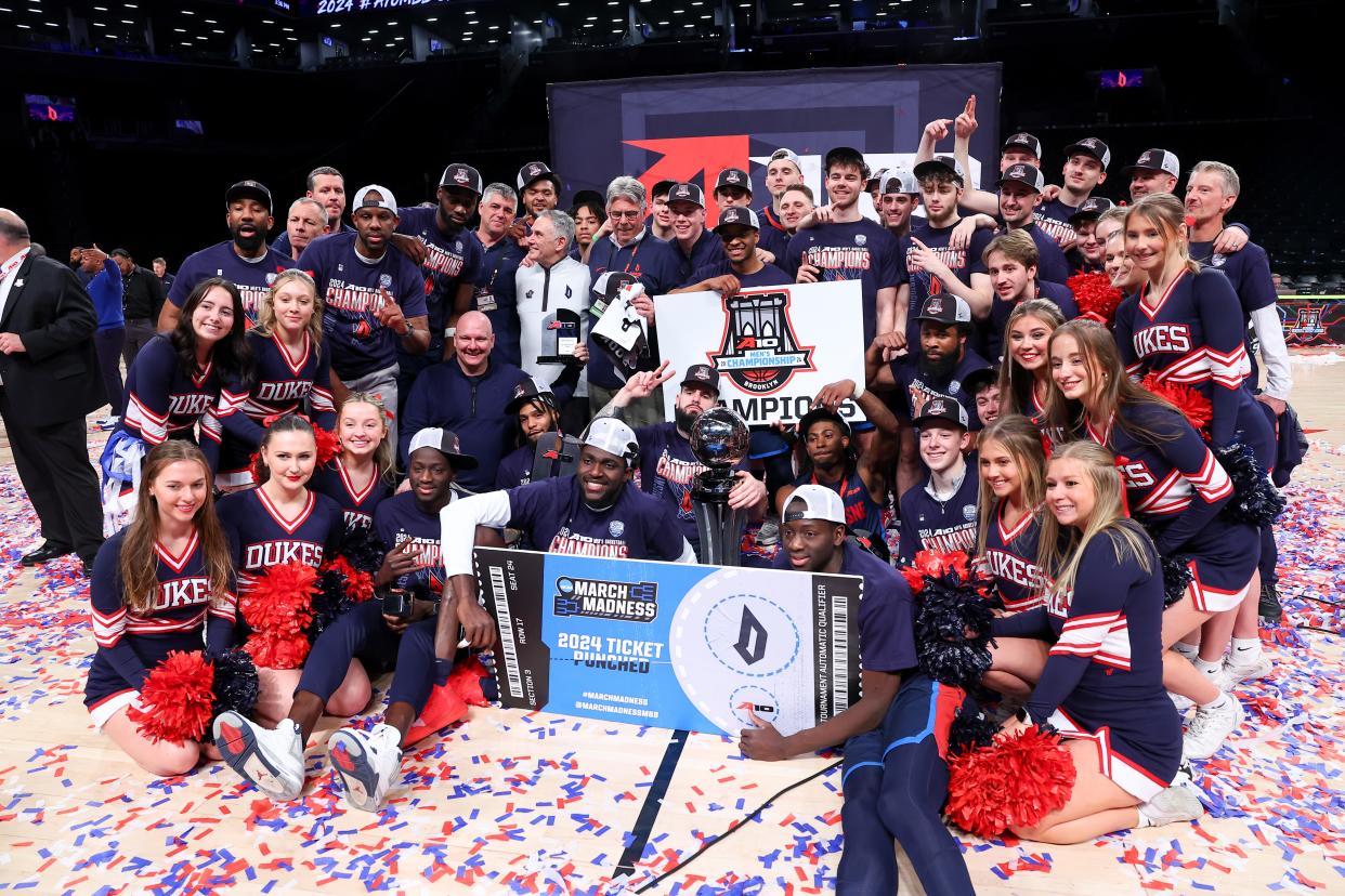 BROOKLYN, NY - MARCH 17:  The Duquesne Dukes celebrate with the Trophy and their ticket for the NCAA Basketball Tournament after winning the Atlantic 10 Tournament against the Virginia Commonwealth Rams on March 17, 2024 at the Barclays Center in Brooklyn, New York.  (Photo by Rich Graessle/Icon Sportswire via Getty Images)