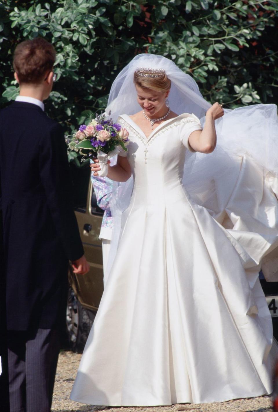 <p>Lady Helen Windsor stunned in a bespoke Catherine Walker bridal gown for her wedding to Timothy Taylor. The bride's Tudor-style gown featured structured off-the-shoulder sleeves and gold embroidery details. </p>