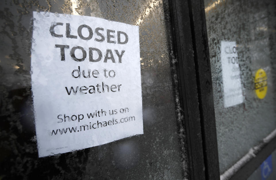A sign tells shoppers that a craft store is closed as a late winter storm packing hurricane-force winds and snow sweeps over the intermountain West Wednesday, March 13, 2019, in Denver. (AP Photo/David Zalubowski)