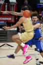 Kentucky guard Devin Askew, right, passes the ball as Georgia Tech guard Jordan Usher, left, defends during the second half of an NCAA college basketball game Sunday, Dec. 6, 2020, in Atlanta. (AP Photo/John Bazemore)