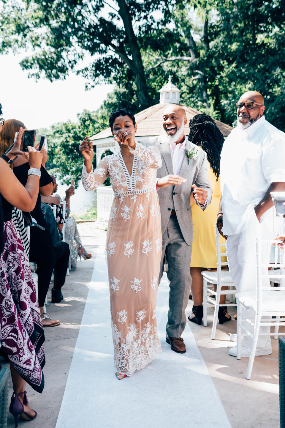 Anthony and Dajuana Mayers cheerfully walking down the aisle at their vow renewal ceremony. (Photo: Catherine Rogers)