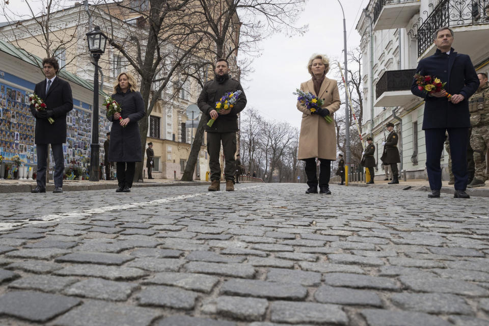 In this photo provided by the Ukrainian Presidential Press Office, from right, Belgian Prime Minister Alexander De Croo, EU Commission President Ursula von der Leyen, Ukrainian President Volodymyr Zelenskyy, Italy's Premier Giorgia Meloni and Canadian Prime Minister Justin Trudeau attend a laying of flowers ceremony at the Memory Wall of Fallen Defenders of Ukraine, in Kyiv, Ukraine, Saturday, Feb. 24, 2024. Zelenskyy has welcomed Western leaders to Kyiv to mark the second anniversary of Russia's full-scale invasion, as Ukrainian forces run low on ammunition and foreign aid hangs in the balance. (Ukrainian Presidential Press Office via AP)
