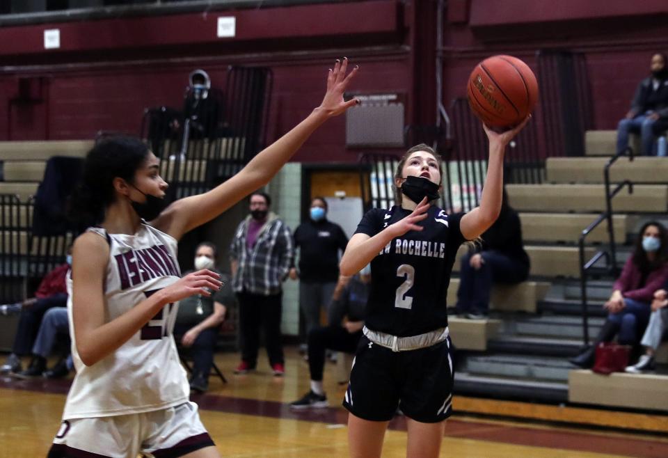 From right, New Rochelle's Rylie Rosenberg (2) puts up a shot in front of Ossining's Karen Perriott (21) during girls basketball action at Ossining High School on Thursday. New Rochelle won the game.