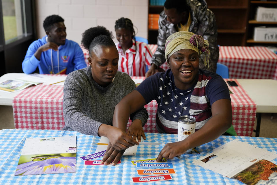 Leliz Bonilla Castro, left, and her sister Xochina Michelle Castro, refugees from Honduras, participate in an English class, Thursday, April 11, 2024, in Columbia, S.C. The American refugee program, which long served as a haven for people fleeing violence around the world, is rebounding from years of dwindling arrivals under former President Donald Trump. The Biden administration has worked to restaff refugee resettlement agencies and streamline the process of vetting and placing people in America. (AP Photo/Erik Verduzco)