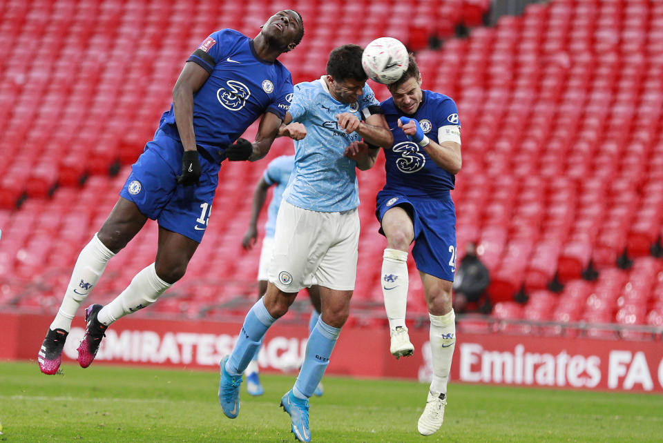 Manchester City's Rodrigo, center, jumps for the ball with Chelsea's Mason Mount, left, and Chelsea's Cesar Azpilicueta during the English FA Cup semifinal soccer match between Chelsea and Manchester City at Wembley Stadium in London, England, Saturday, April 17, 2021. (AP Photo/Ian Walton, Pool)