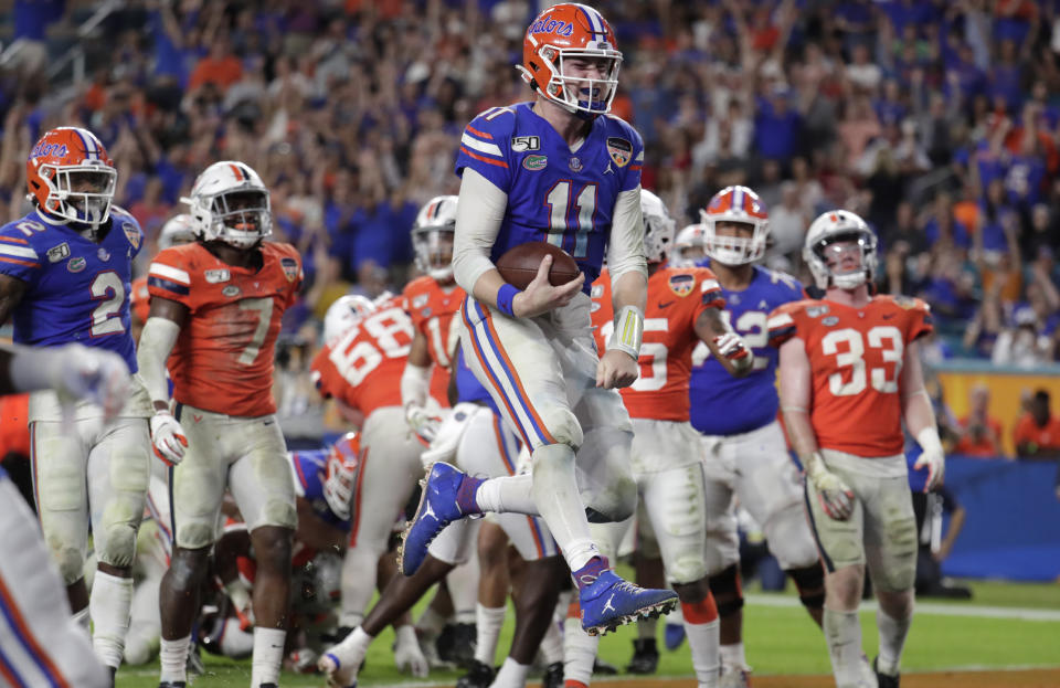 Florida quarterback Kyle Trask (11) scores a touchdown during the second half of the Orange Bowl NCAA college football game against Virginia, Monday, Dec. 30, 2019, in Miami Gardens, Fla. (AP Photo/Lynne Sladky)