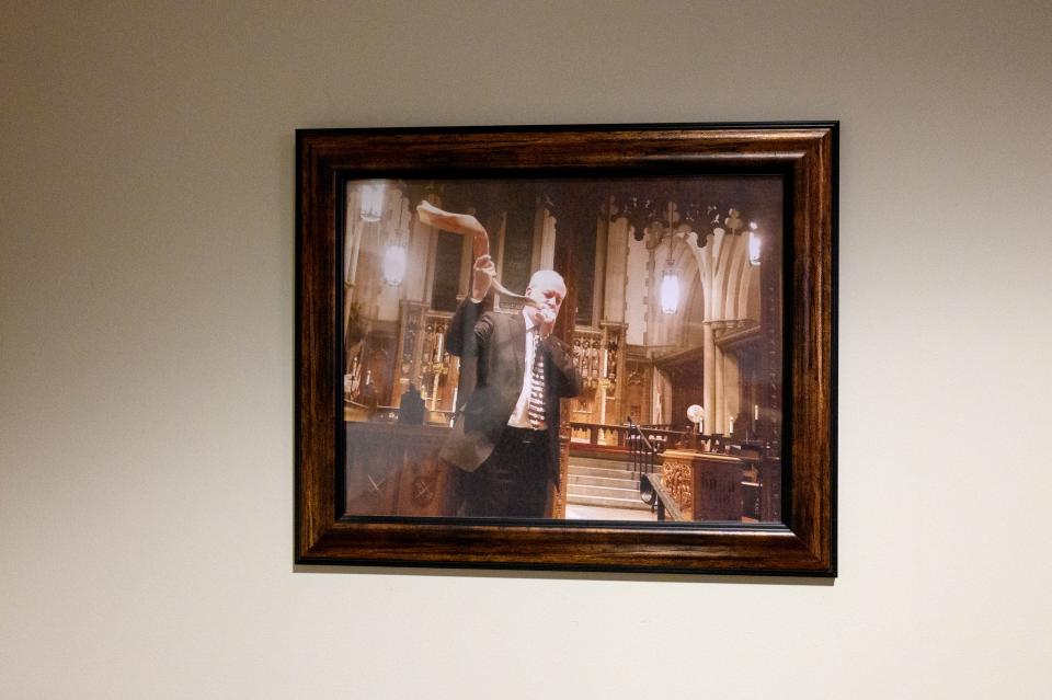A photo of Tree of Life synagogue's Rabbi Jeffrey Myers playing the shofar hangs in the Calvary Episcopal Church on Thursday, Oct. 26, 2023, in Pittsburgh's Shadyside neighborhood.