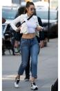 <p>In a white denim jacket, crop top, low-rise jeans and Hogan sneakers out in NYC. </p>