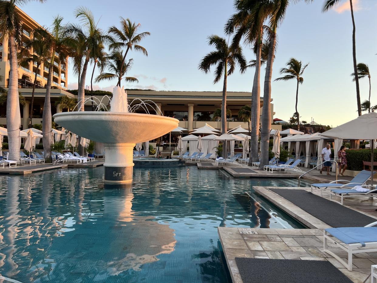 A photo of a pool with a fountain at the Four Seasons Maui.