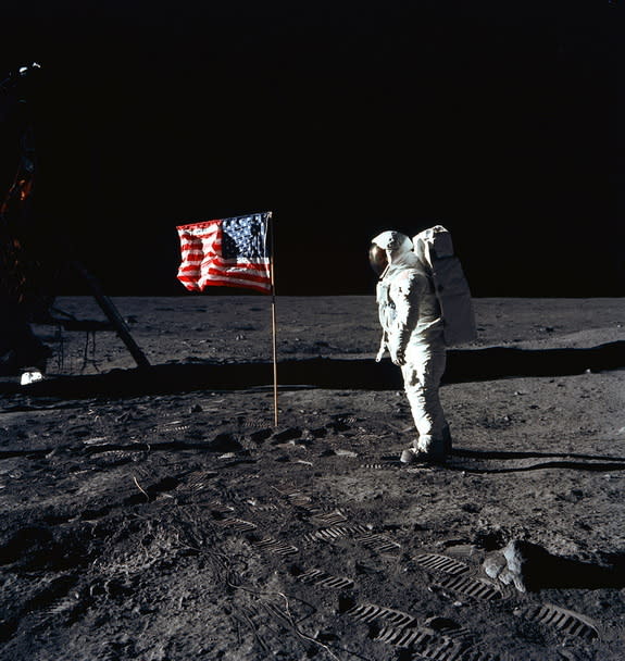 Apollo 11 lunar module pilot Buzz Aldrin stands on the moon near the American flag during NASA's historic first manned moon landing on July 20, 1969. Apollo 11 commander Neil Armstrong took the photo.