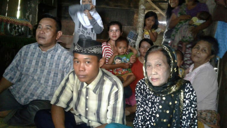 This undated recent photograph shows 73-year-old Rohaya binti Kiagus Muhammad Jakfar (front 2nd R) sitting with her 15-year-old teenage husband Selamet Riyadi (front 2nd L) in Baturaja, South Sumatra province