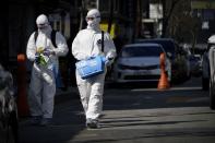 Employees from a disinfection service company sanitize a shopping district in Seoul