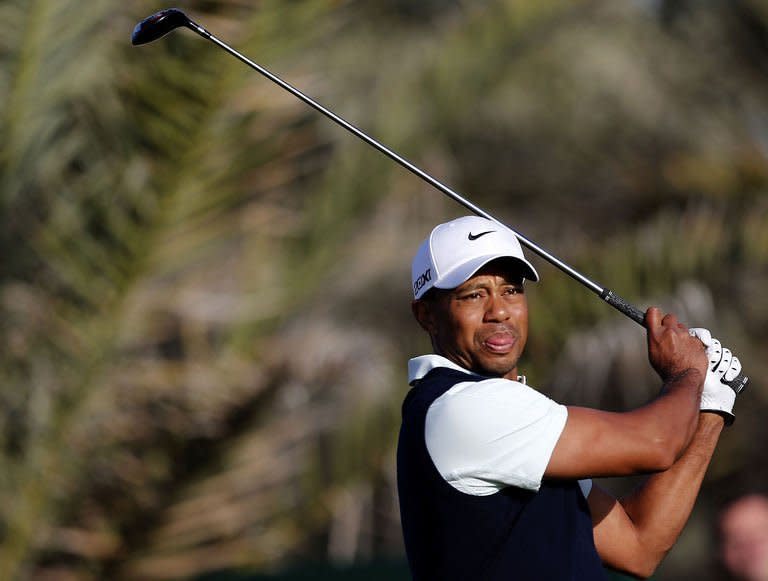 US golfer Tiger Woods plays a shot during the first round of the Abu Dhabi Golf Championship at the Abu Dhabi Golf Club in the Emirati capital on January 17, 2013. Justin Rose grabbed a share of the first round lead in the Abu Dhabi Golf Championship on a day when both Rory McIlroy and Woods struggled to get their seasons into gear