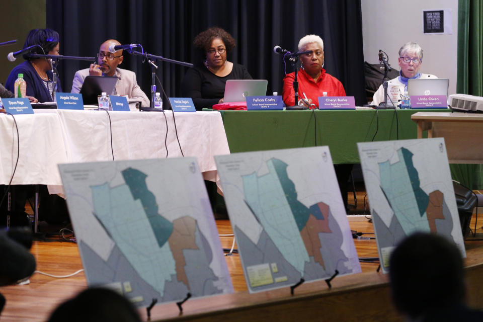 In this Dec. 16, 2019, photo, proposed redistricting maps are lined up during the Richmond School Board's last public hearing on redistricting at Ginter Park Elementary School in Richmond, Va. From New York City to Richmond, sweeping proposals to ease inequities have been scaled back or canceled after encountering a backlash. In Virginia’s capital city, the school board approved a plan that reassigned some students but rejected more sweeping proposals that would have diversified Richmond’s whitest elementary schools. (AP Photo/Steve Helber)