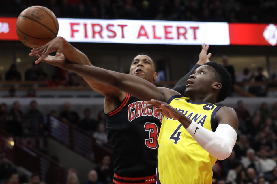 Indiana Pacers guard Victor Oladipo, right, drives to the basket as Chicago Bulls guard Shaquille Harrison defends during the first half of an NBA basketball game in Chicago, Friday, March 6, 2020. (AP Photo/Nam Y. Huh)