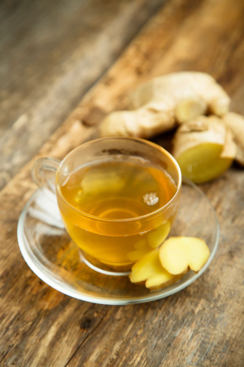 a glass of tea next to a bunch of bananas