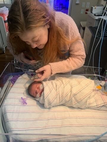 Haley Craft gazing at her newborn child, Dakota Sky.