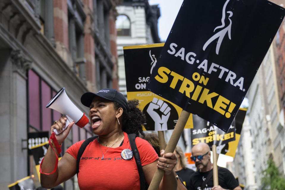 Members of the Writers Guild of America and the Screen Actors Guild walk a picket line outside of Netflix and Warner Bros. Discovery in New York City on Aug. 2, 2023.  (Angela Weiss / AFP - Getty Images)